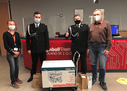 people standing behind a generator box