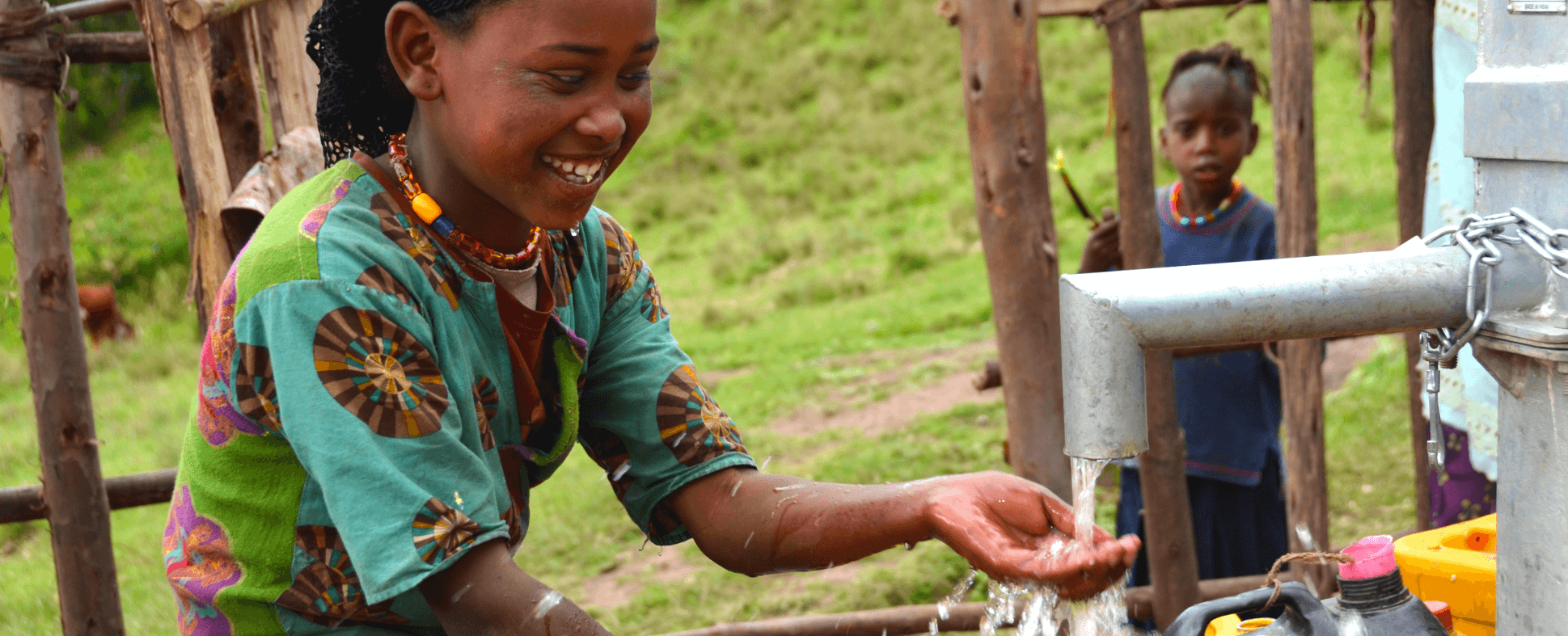 photo of african girl feeling water falling from a pipe