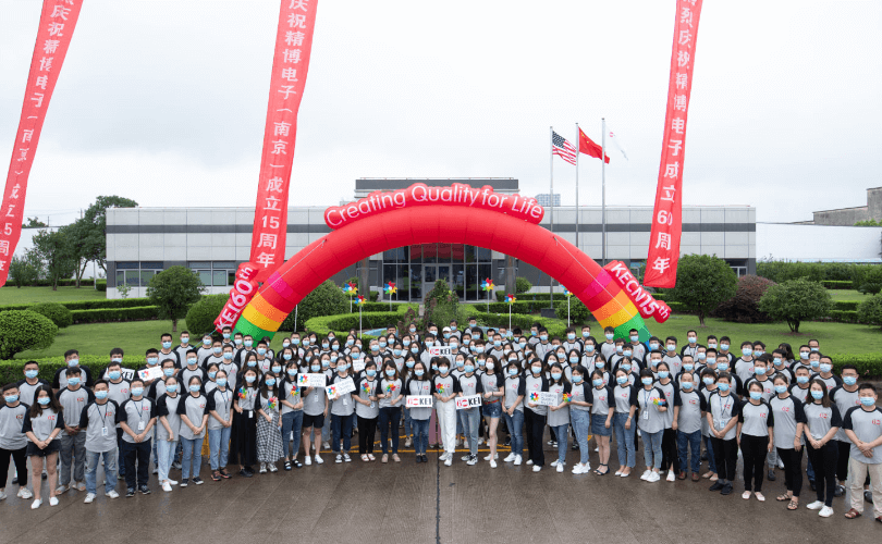 photo of many people standing in front of large building
