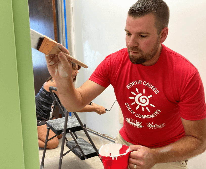 photo of two people painting walls