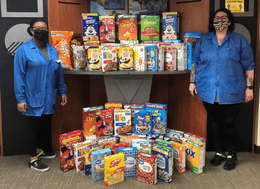 photo of people standing in front of donated food