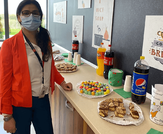 photo of a woman in front of party food